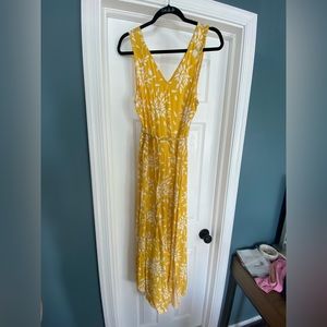 Mid calf length, yellow and white dress. Side slits with waist sinching belt